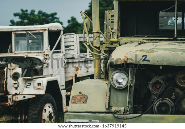 Old wrecked white and green truck.\
Abandoned rusty military truck. Decayed abandoned truck. Tragedy\
and loss. Financial crunch and economic recession concept. Old\
decayed lorries.\
Transportation.