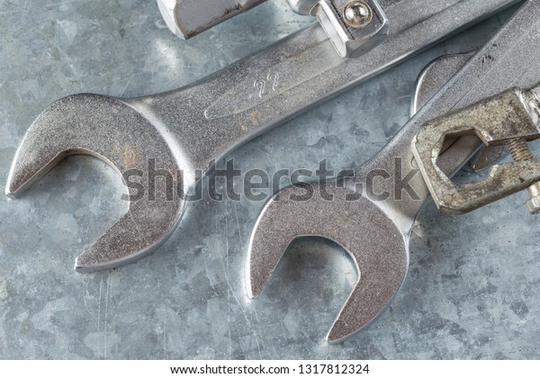 old wrench and tools and Engine spare parts on\
rusty background