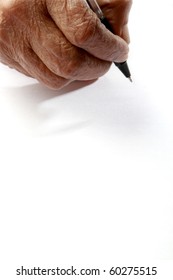 An Old Wrinkled Hand Holding A Pen Against A White Paper Background