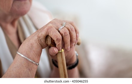 Old Wrinkled Woman Hands Holding Walking Stick