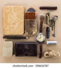 Old wrist watch,notebook,keys,tin spoon,a lighter and other miscellaneous items