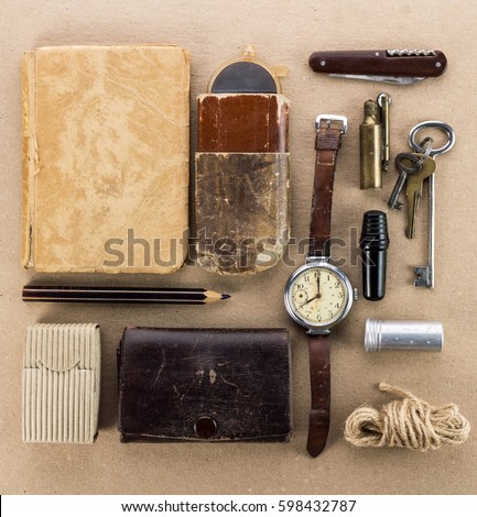 Old wrist watch,notebook,keys,tin spoon,a lighter and other miscellaneous items