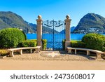 Old wrought iron gate overlooking Lake Lugano in Ciani Park, Lugano, Switzerland