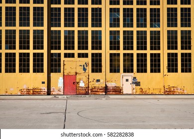 Old Yellow Hangar Doors At A Former Military Base, Showing Rust And Decay In Alameda, California.