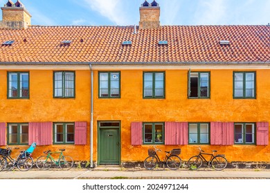 Old yellow house of Nyboder district with bikes. Old Medieval district in Copenhagen, Denmark. Picturesque of Copenhagen
