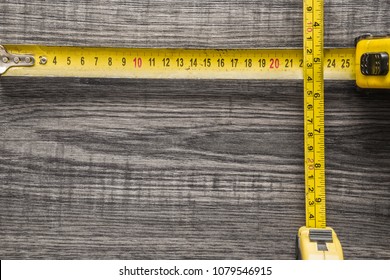 Old, yellow measuring tape on black wooden plank. Mock up for special offers as advertising or other ideas. Frame border corner on dark desk. Empty place for text or logo. - Shutterstock ID 1079546915