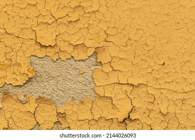Old Yellow Painted Stucco Wall With Chipped Paint. Background Texture.