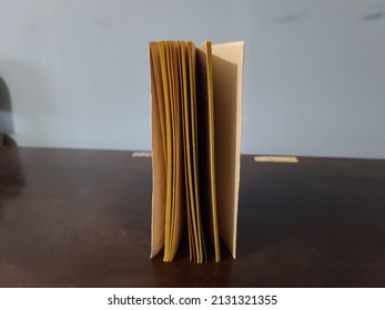 An Old Yellowed Pages Book Standing On Its Side.