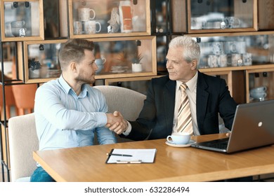 Old And Young Man Handshaking