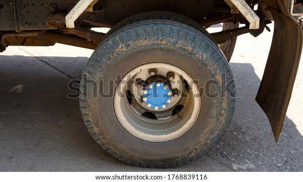    Old,dirty wheel of big truck in car park           \
                