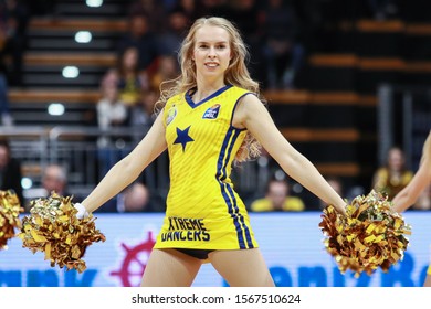 Oldenburg, Germany, November 20, 2019: Blonde Cheerleader Of The EWE Baskets Oldenburg Dancing During A Eurocup Match At The Kleine EWE Arena.
