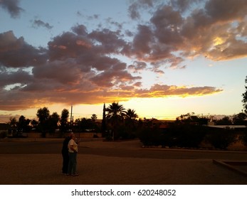 Older Adults Couple Watching The Sunset With A Dramatic Sky. Tucson, AZ, Circa January 2017.