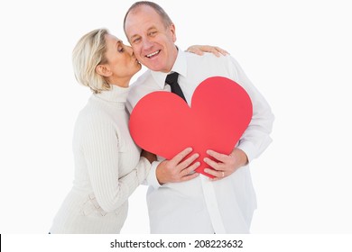 Older Affectionate Couple Holding Red Heart Shape On White Background