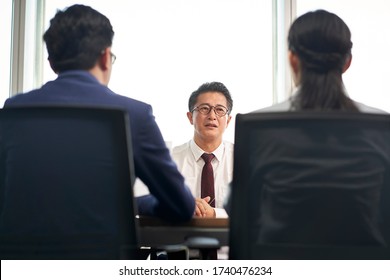 Older Asian Business Man Job Seeker Being Interviewed By Young Human Resources Executives