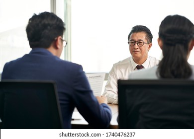 Older Asian Business Man Job Seeker Being Interviewed By Young Human Resources Executives