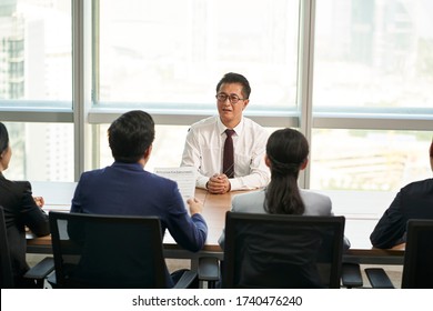 Older Asian Business Man Job Seeker Being Interviewed By A Group Of Young Human Resources Executives