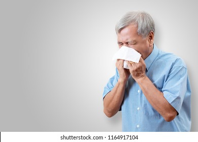 Older Asian Man Is Having Flu And Sneezing From Sickness Seasonal Virus Problem With Isolated Background. Fever And Cold In Senior People With Influenza Illness And Health Insurance Concept.