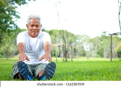 Older Asian Men Exercise In The Park