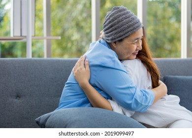 Older Asian Woman Patient Covered The Head With Clothes Effect From Chemo Treatment In Cancer Cure Process Hugging Her Daughter With Love And Happy.