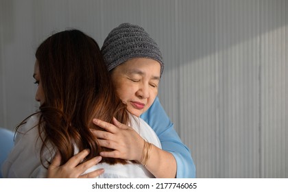 Older Asian Woman Patient Covered The Head With Clothes Effect From Chemo Treatment In Cancer Cure Process Hugging Her Daughter With Love And Happy.