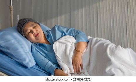 Older Asian Woman Patient Covered The Head With Clothes Effect From Chemo Treatment In Cancer Cure Process Laying On Hospital Bed With Suffer And Lonely.