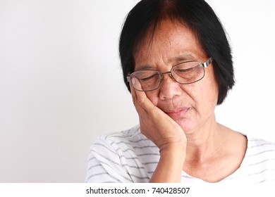 Older Asian Women Are Sad Because Of Toothache.