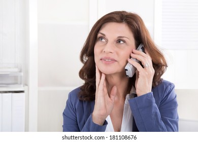 Older Attractive Business Woman Making A Phone Call.