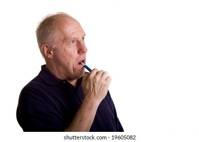 An Older Bald Man Brushing His Teeth