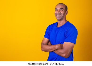 Older Black Man Confidently Crossing His Arms. Optimistic, Happy. Happy. Afro Man With Arms Crossed On Yellow Background