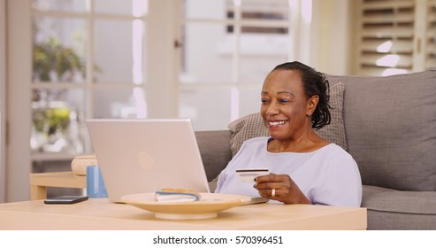 An Older Black Woman Pays Her Bills On Her Laptop