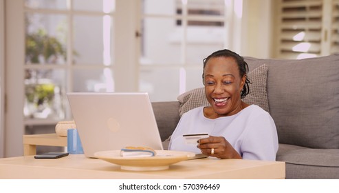 An Older Black Woman Pays Her Bills On Her Laptop