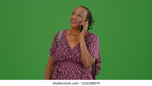 A Older Black Woman Taking A Mobile Phone Call On Green Screen