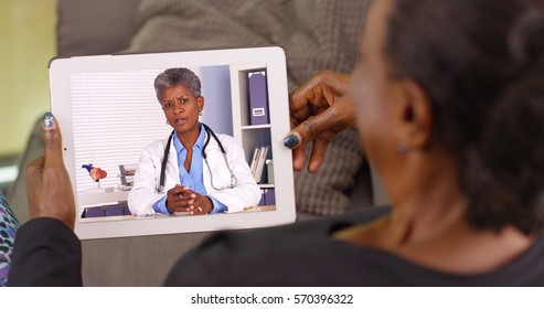 An Older Black Woman Talking To Her African American Doctor Via Video Chat