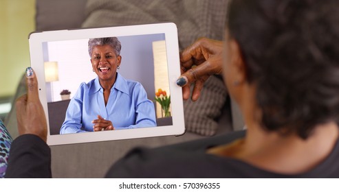 An Older Black Woman Talking To Her Friend Via Video Chat