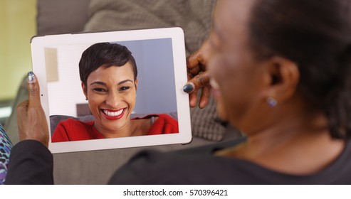 An Older Black Woman Talking To Her Daughter Via Video Chat