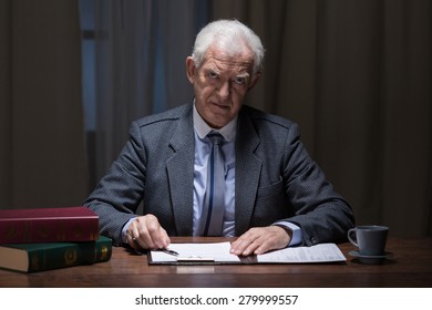 Older busy man working late at night in his cabinet - Powered by Shutterstock