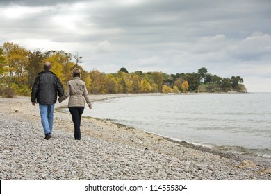 Older Casual Couple Walking In The Park Outdoors