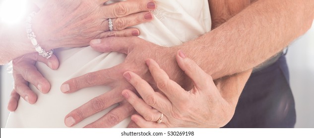 Older Couple Cuddling Together When Man Embracing His Wife's Waist