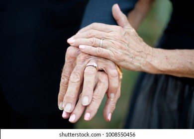 Older Couple Displaying Their Wedding Rings After Getting Married. Their Hands Show The Beauty Of Time, And Set Forth The Idea That You Are Never Too Old For Love Or Marriage.