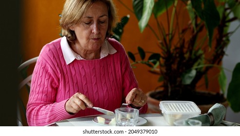 Older Couple Eating Lunch Together, Candid Authentic Real Life Senior Couple At Home Balcony