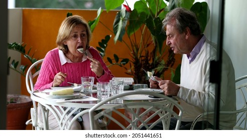 Older Couple Eating Lunch Together, Candid Authentic Real Life Senior Couple At Home Balcony