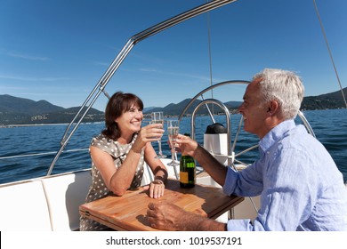 Older Couple Having Champagne On Boat