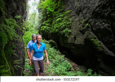 Older Couple Hiking In The Forest