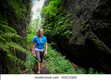 Older Couple Hiking In The Forest