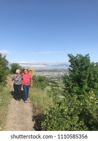 An Older Couple Hiking In The Utah Mountains.