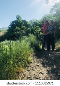 An Older Couple Hiking In The Utah Mountains.