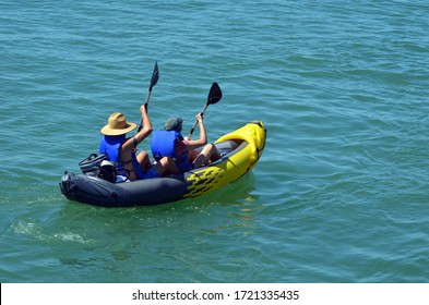 Older Couple Kayaking In An Inflatable Kayak On Biscayne Bay Off Miami Beach,Florida