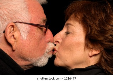 Older Couple In Love Kisses