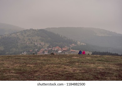 Older Couple On Mountain Top With Fog