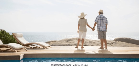 Older couple overlooking ocean from balcony - Powered by Shutterstock